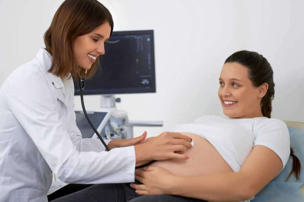 doctor-using-stethoscope-examining-pregnant-woman